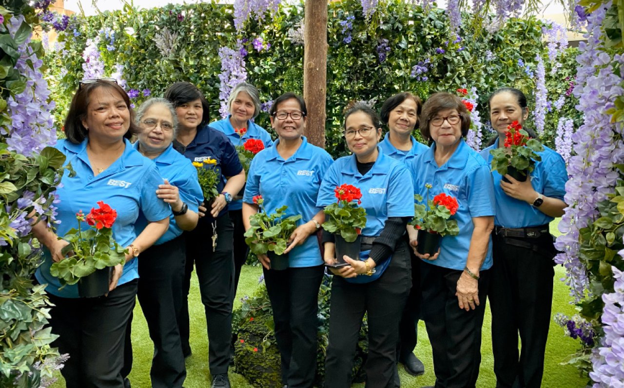 Female staff members celebrating Mother's Day with flowers.